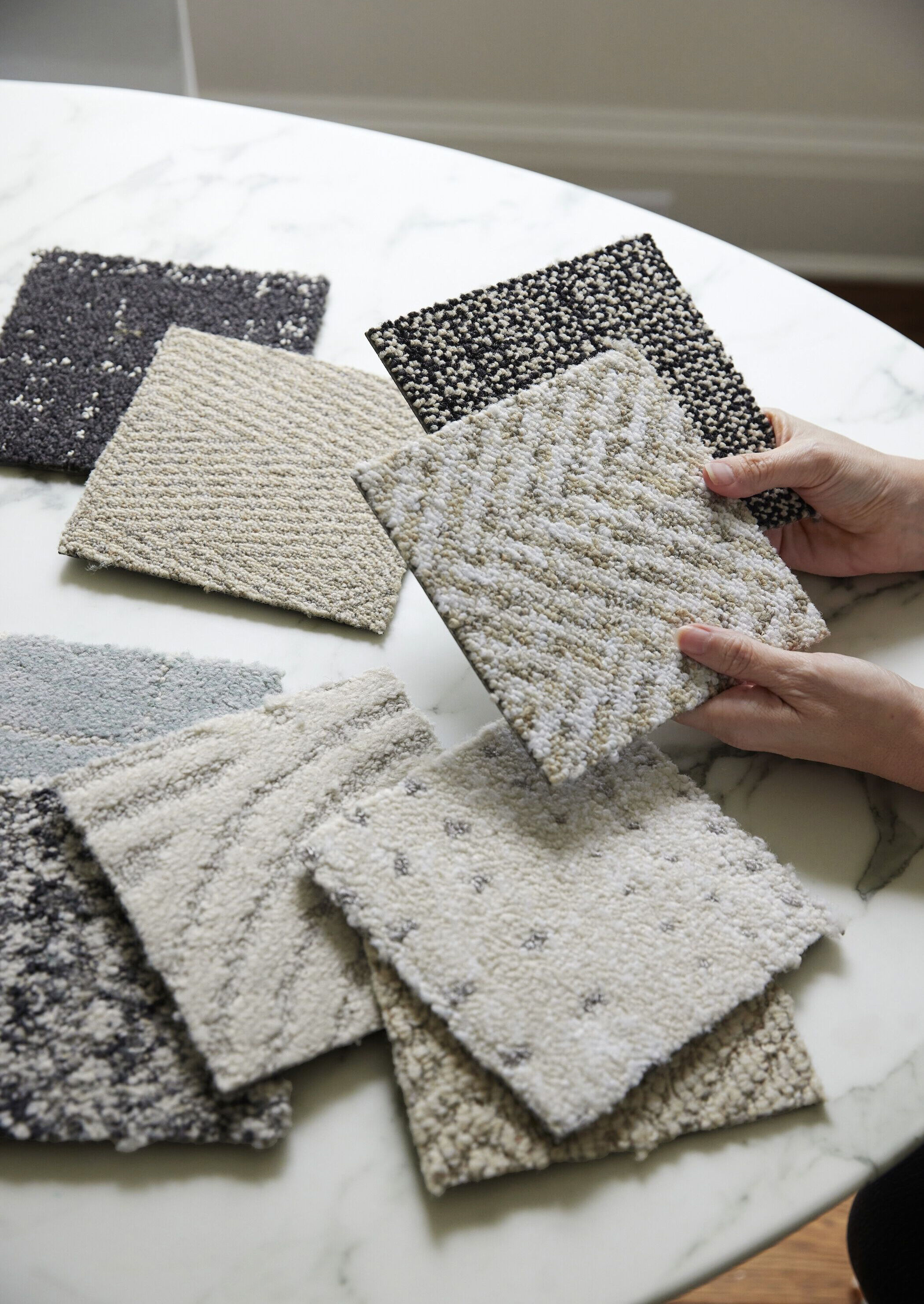 Hands holding FLOR Carpet Tile Samples